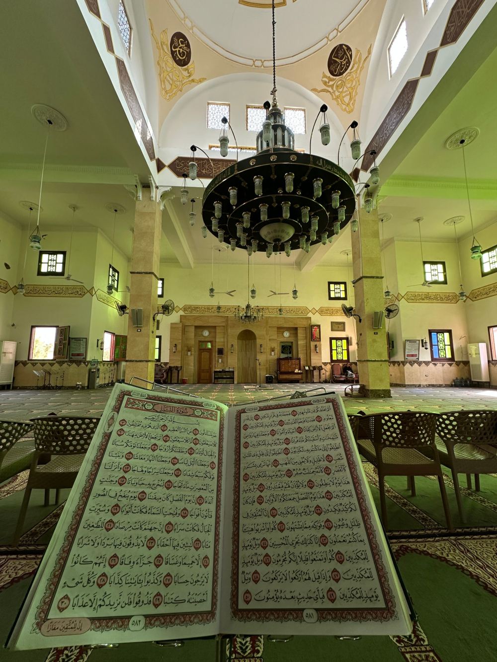 An open mushaf on a rehal in the prayer hall of a mosque